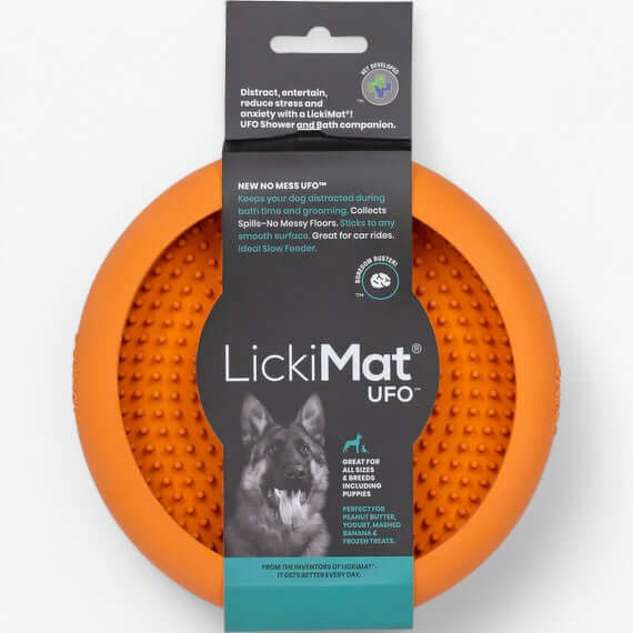 LickiMat UFO orange slow feeder for dogs, designed to reduce stress during grooming with suction cups.